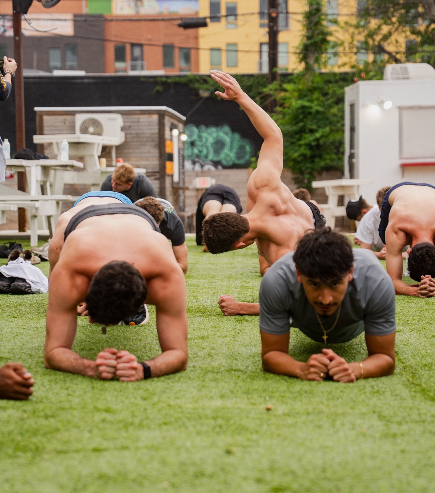 Royalty Renewables reps doing planks together on turf
